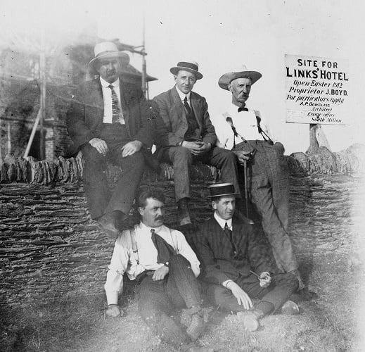 Pre 1912 Five men sitting on the wall outside uncompleted Links Hotel, Thurlestone. 
Back row: Joshua Boyce (in charge of building hotel), Edward John Tanner (clothier), Langworthy (butcher).  
Front row: unknown, William Stubbs (visitor on business with Tanner).