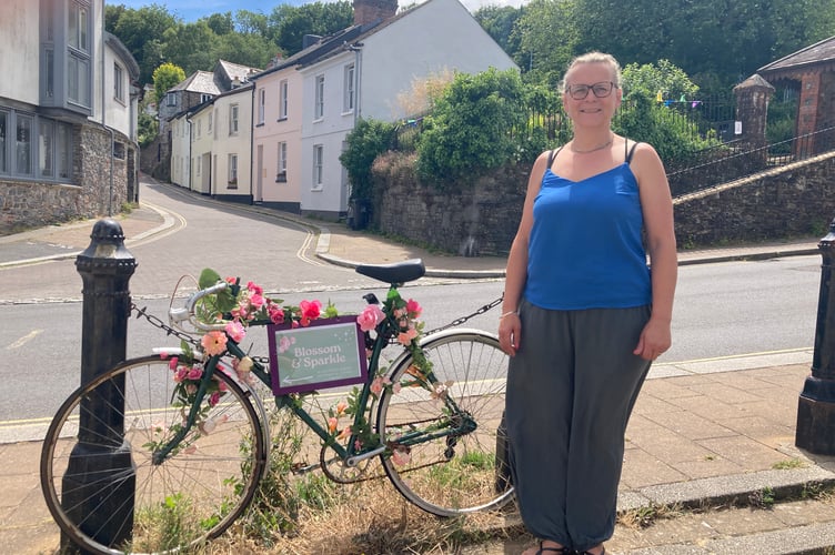 Corrine Turner with the bicycle she decorated as a sign