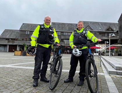 Two police officers with e-bikes