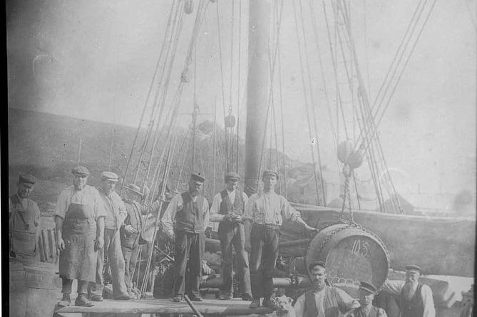 'Effort' alongside quay, shows crew (and dog).
The 85 ton ketch Effort, 67 feet in length, was built by William Date in 1880. 