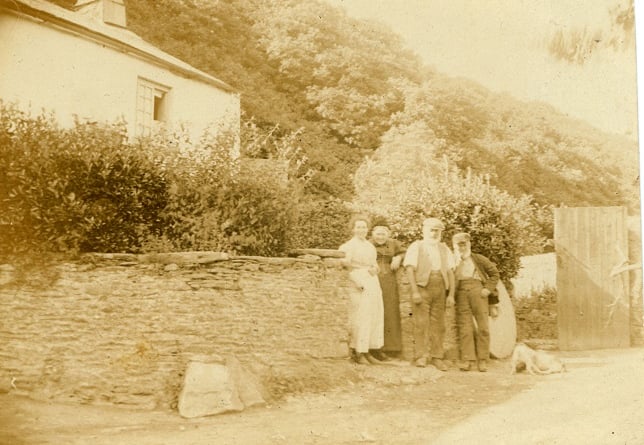 Group at gate (1900 circa), Loddiswell. Louisa Hambly in white dress, her mother Mrs Barons, Henry Hambly and possibly Mr Barons snr, Millstone against the wall behind group was still there up to 1946. Stones at foot of wall to save damage from carts in and out of the mill.