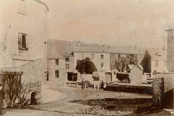 Low wall to centre right marked end of Kingsbridge creek. Grant's Coal Stores on left of picture listed in Kelly's Directory 1889 as in Mill Street. Covered wagons in background in front of what is now Harbour House