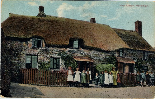 1912 Woodleigh Post Office with thatched roof, woman and children outside. (Post office was closed in 1971).